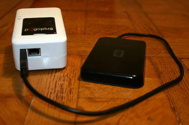 Pogoplug, meet your new buddy — a USB hard drive. The open socket is for the ethernet cable.  