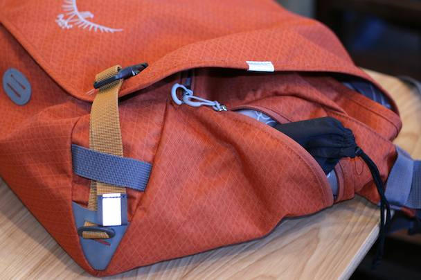 The zippered side pocket is perfect for stowing sunglasses. Note the swapped out orange buckle webbing; probably makes a bigger splash with the bag's other available colors, black and khaki