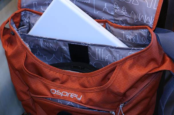 The bag's padded laptop sleeve comfortably swallows a 15" MBP (13" Macbook in the photo, though) and is suspended above the bag's bottom.