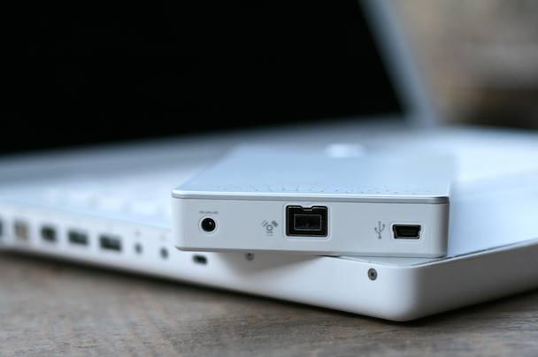 The wee hole on the far left is for auxiliary power, which is supposed to power the drive's power-hungry 7200 rpm spindle when used with underpowered USB ports. 