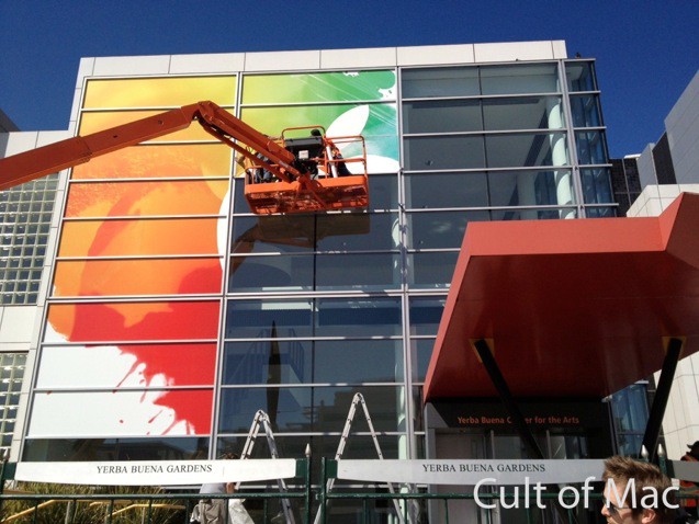 the Apple logo centered around a colorful background