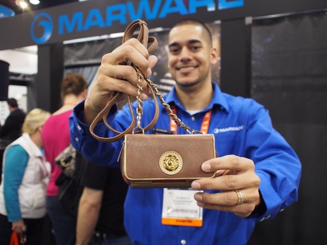 Ronnie Khadaran, Marware's director of marketing, holds up the Zoey, a purse for the iPhone 5.