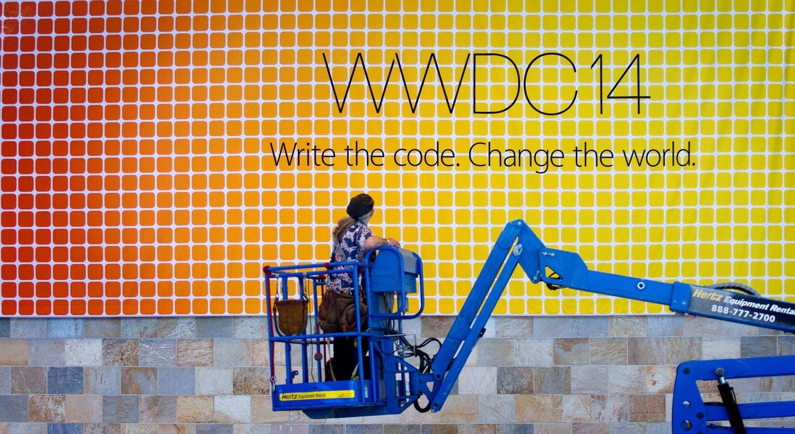 The 2014 WWDC banner gets the drop down at San Francisco's Moscone Center Tuesday afternoon May 27, 2014. Photo: Jim Merithew/Cult of Mac