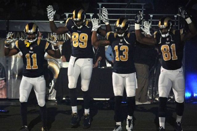 Members of the Rams raised their arms during pregame introductions as a salute to nearby Ferguson, Missouri. (L.G. Patterson/Associated Press) 