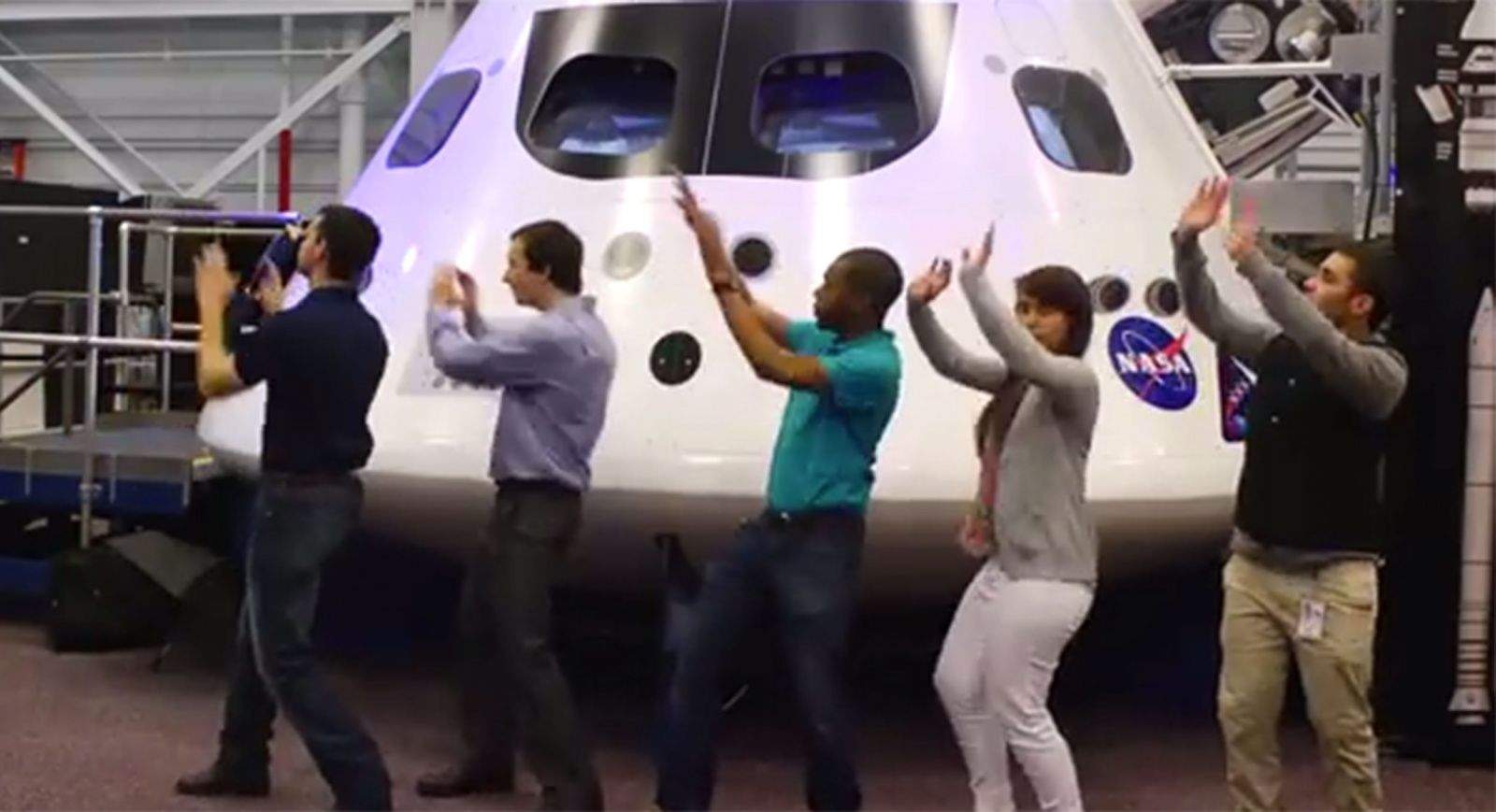 A dance line of NASA interns from a scene in their parody music video called 
