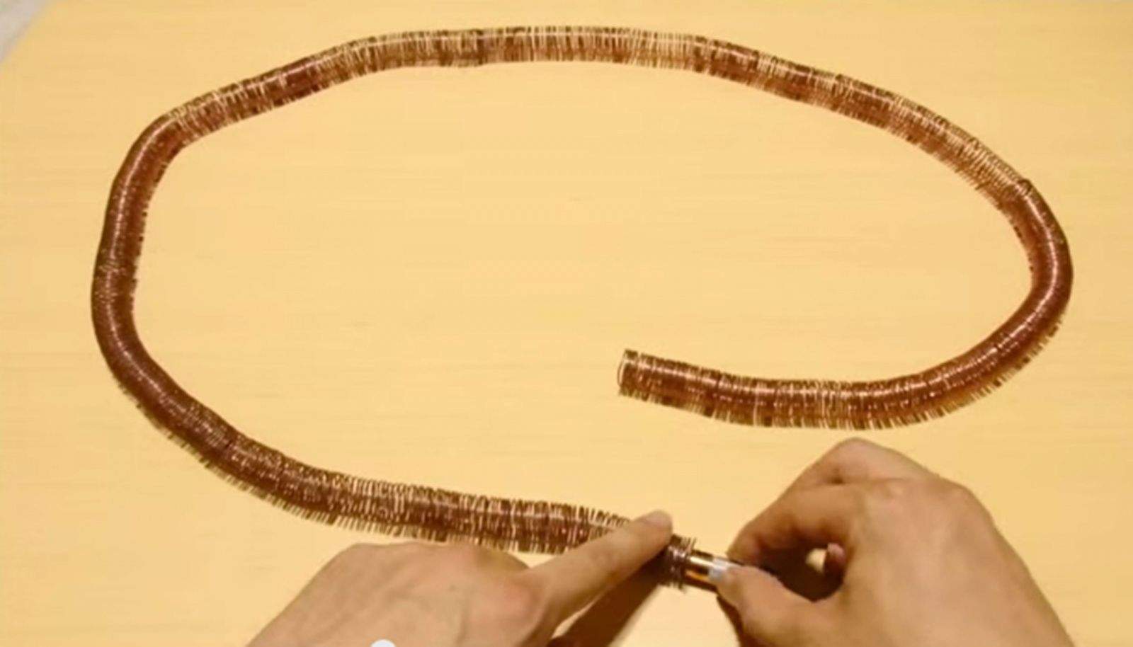 Transform copper wire, magnets and a battery into a simple electric train. Screen grab from Amazing Science YouTube video