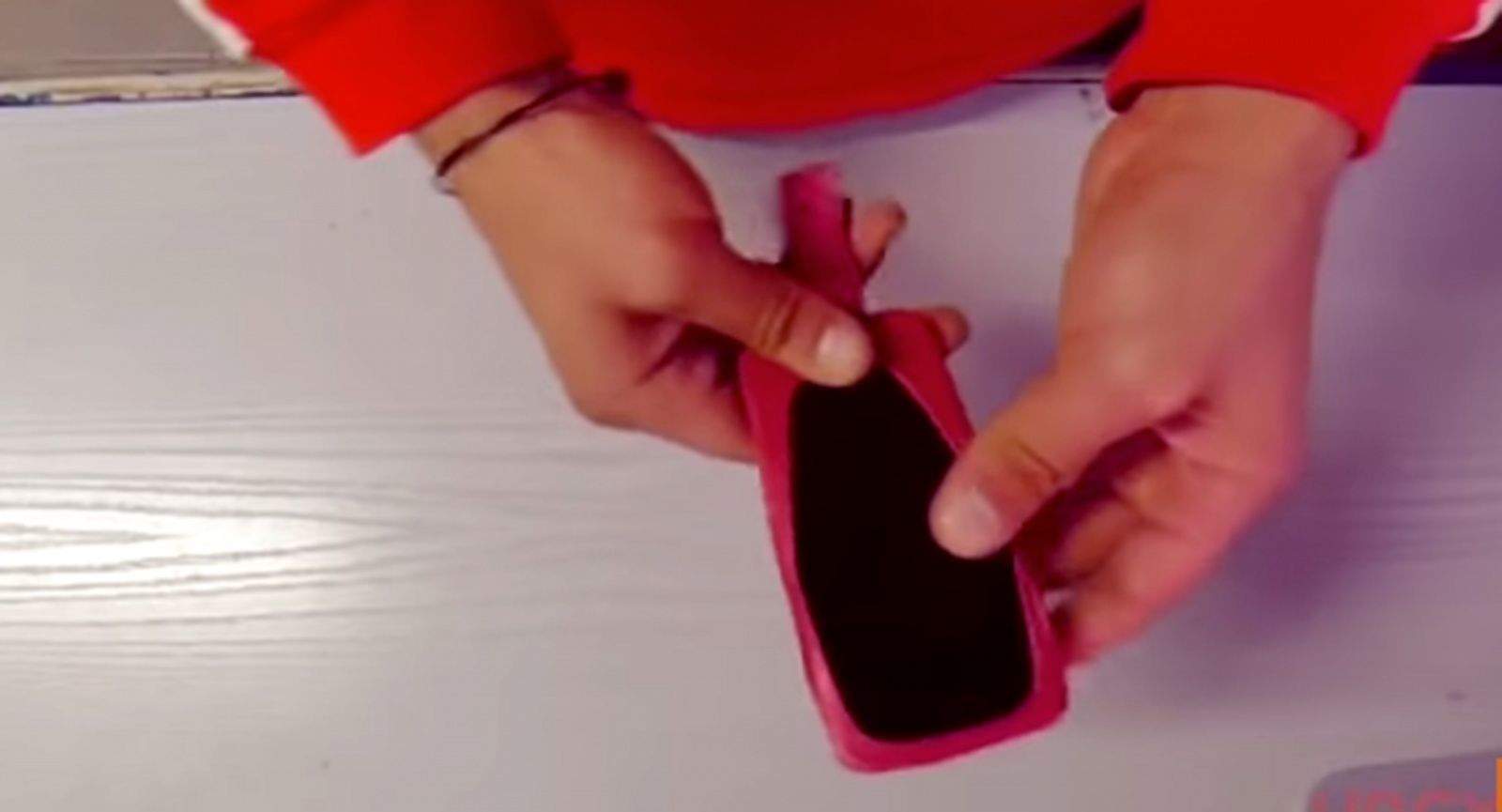 A balloon can make a quick iPhone cover in a pinch, but is not recommended. Photo: Storyful/YouTube