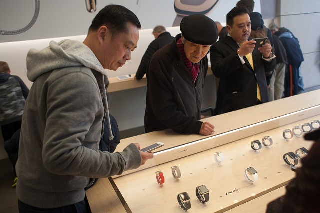 An Apple fan takes an iPhone photo of two gold Apple Watches on display. Photo: David Pierini/Cult of Mac