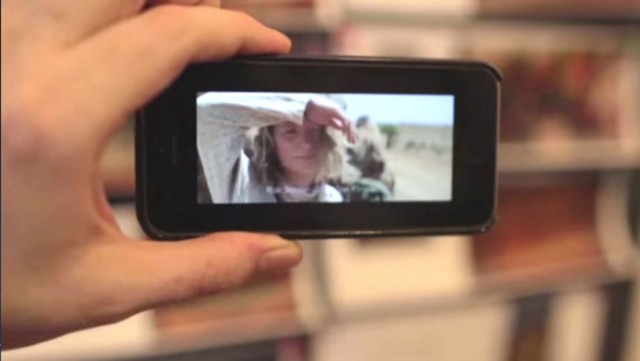 With the Aurasma app, a reader of INSIDE TRACKS can point the phone at a picture and view a corresponding scene from the movie, TRACKS. Photo: Against All Odds Productions/YouTube