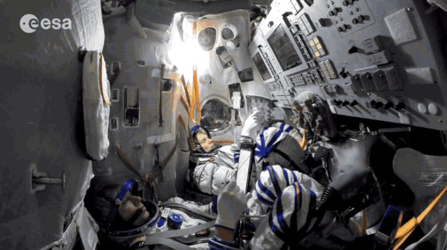 ESA astronaut Andreas Mogensen, left, and Russian cosmonaut Sergei Volkov work through artificial fire aboard a Soyuz simulator.