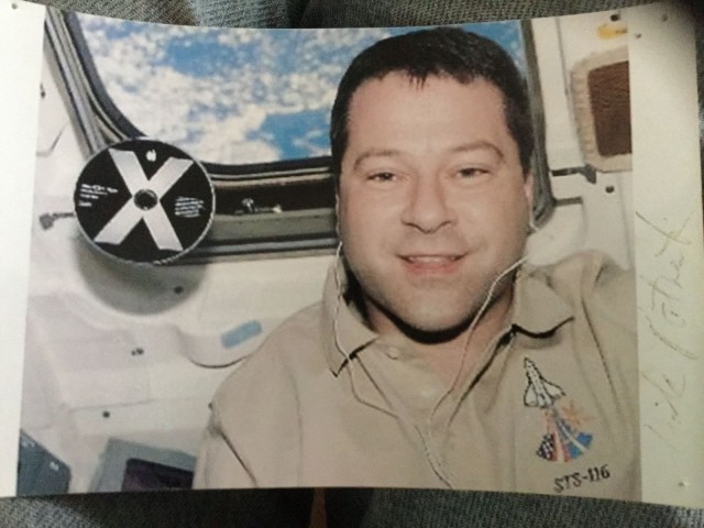 A photo from MacAbbott's Mac Museum shows astronaut Nick Patrick aboard the space shuttle Discovery with an OS X Panther disc floating near his head.
