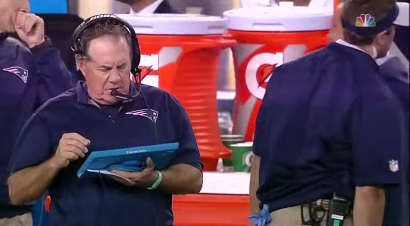 Patriots coach Bill Belichick on the sidelines with an 'iPad.'