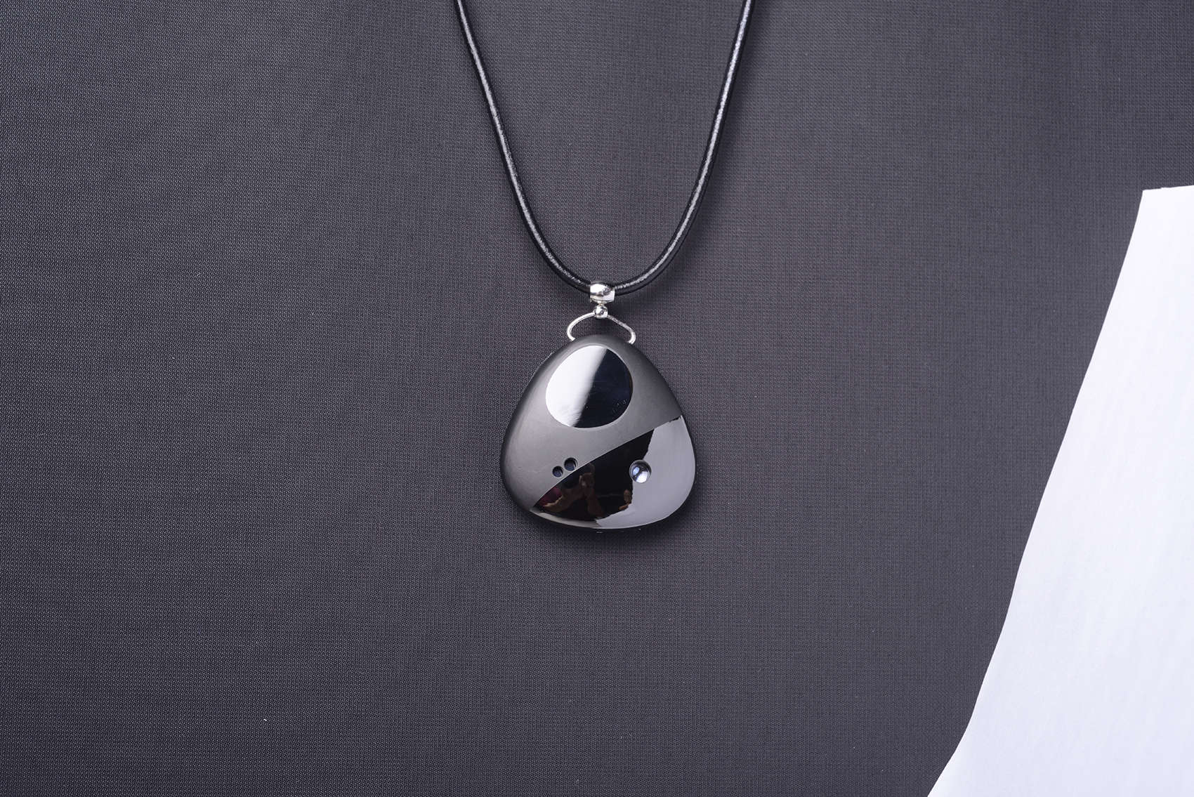 The Miragii pendant can project messages onto your hand and stores an earpiece for calls or music.
