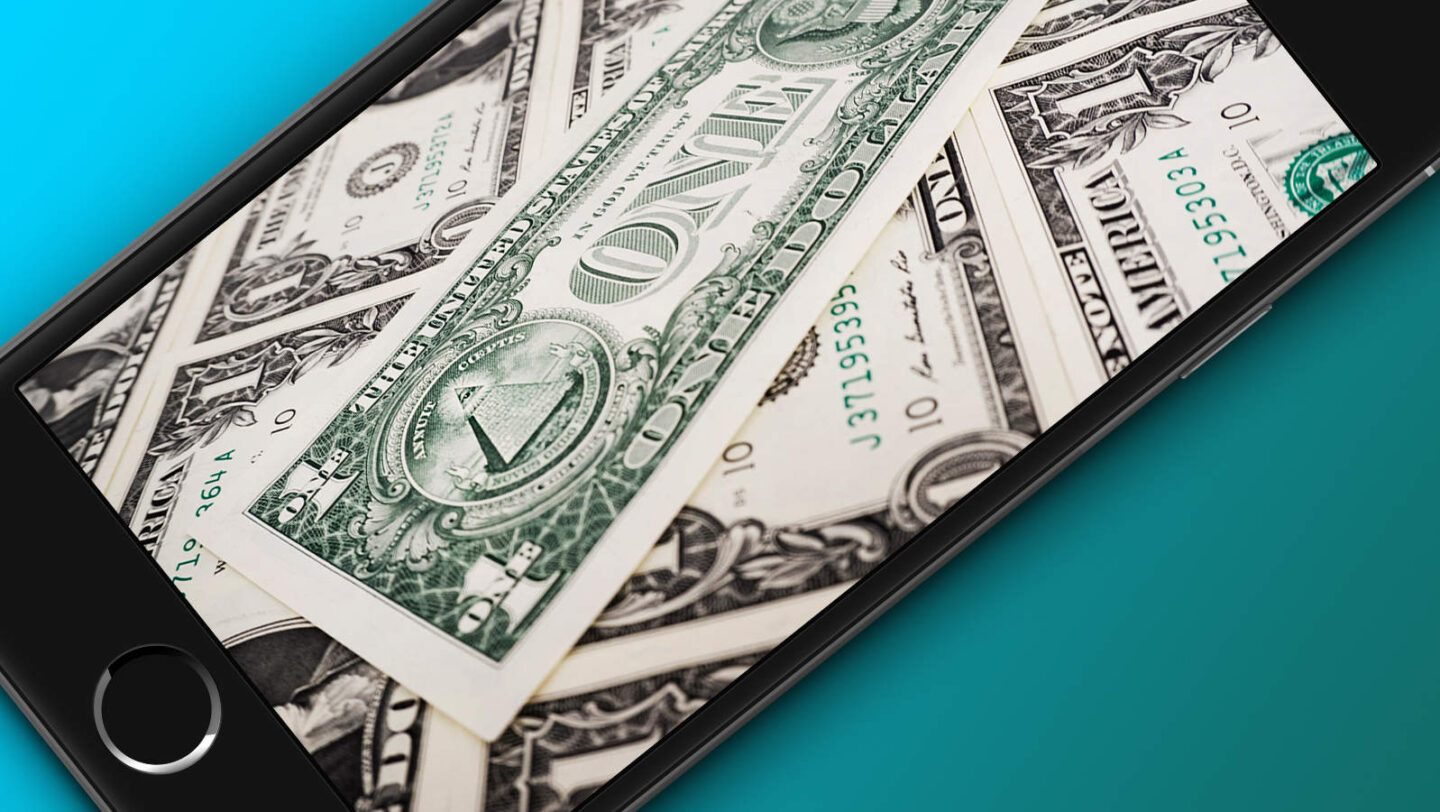 A photo of an iPhone with U.S. money on the screen