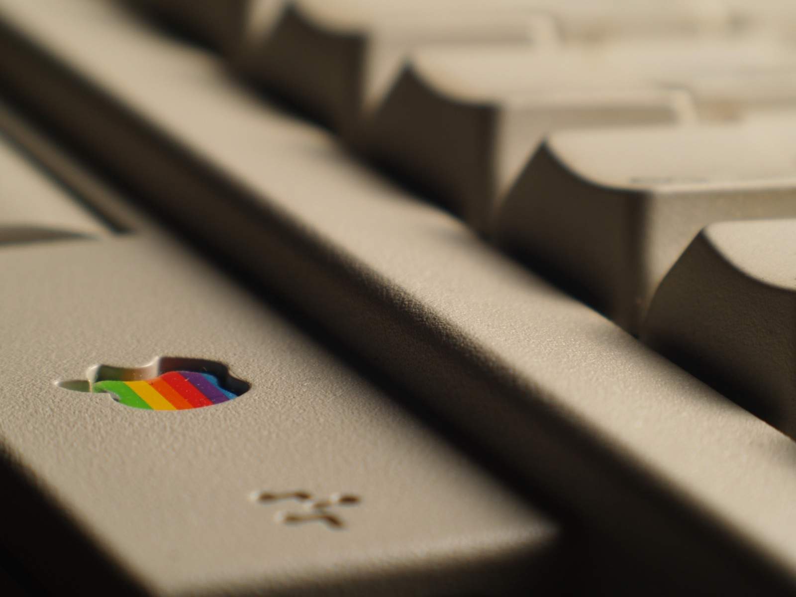 Close-up of vintage Apple Keyboard II with rainbow Apple logo