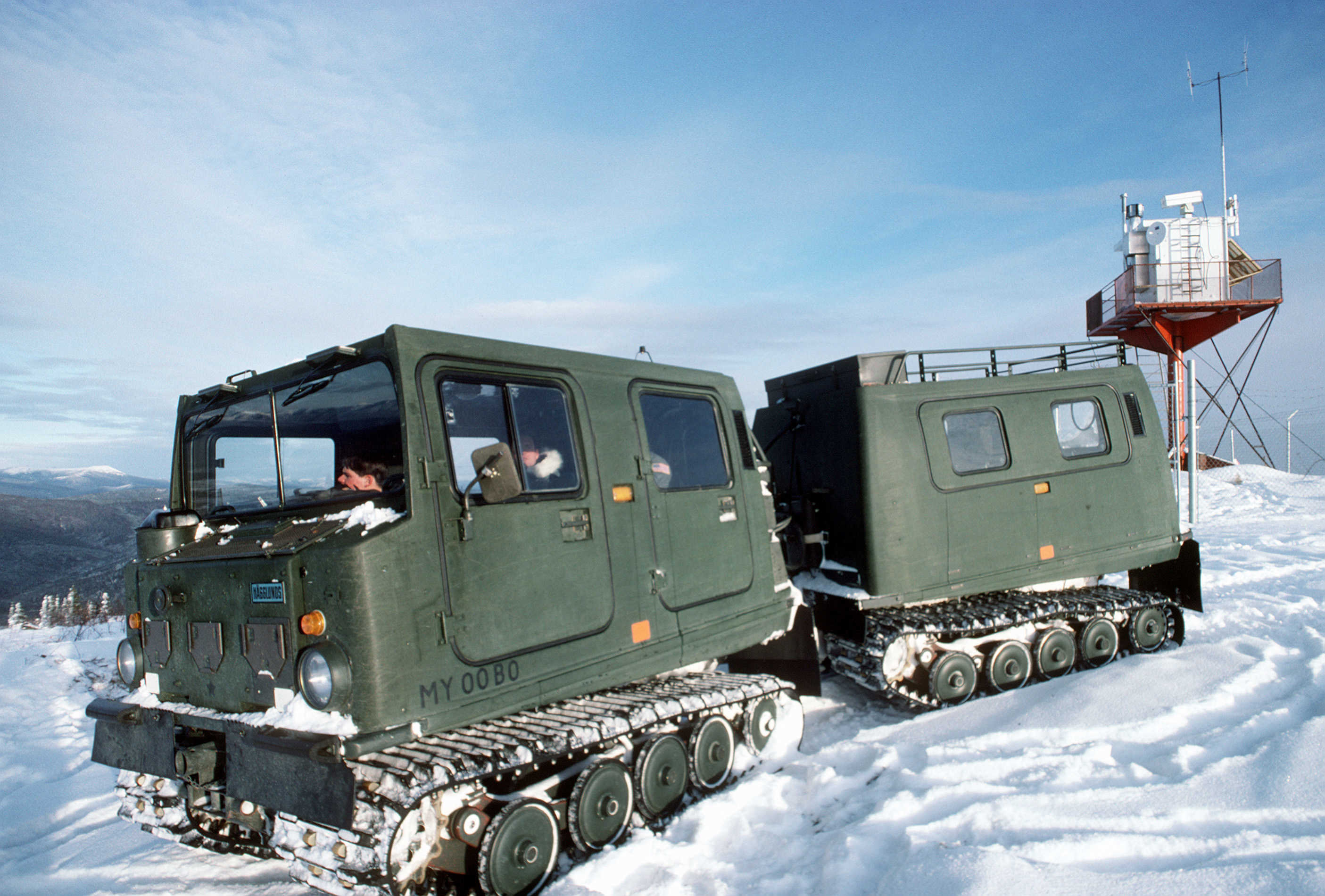 Maintenance personnel from the 5055th Range Squadron drive an M-973 small unit support vehicle through the snow.