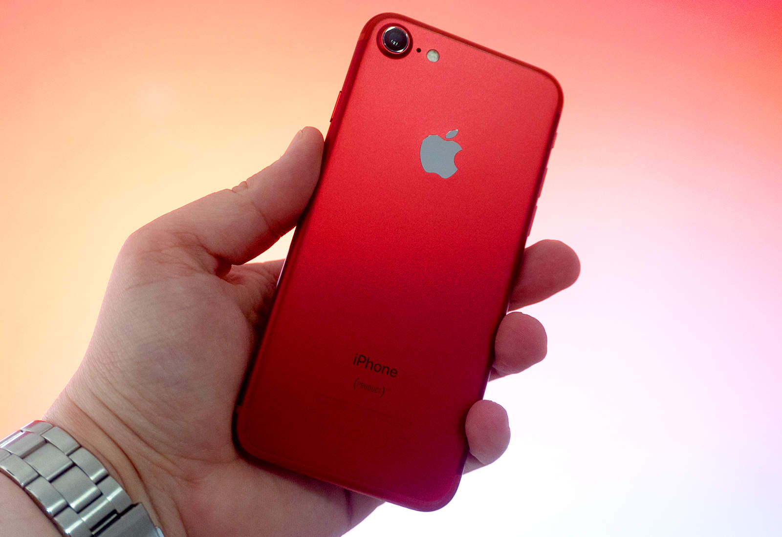 Red iPhone in hand