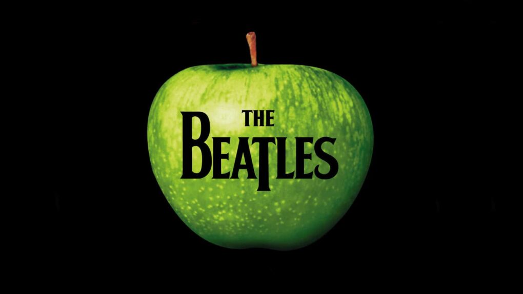 Image of a green apple with The Beatles logo superimposed upon it, with a black background