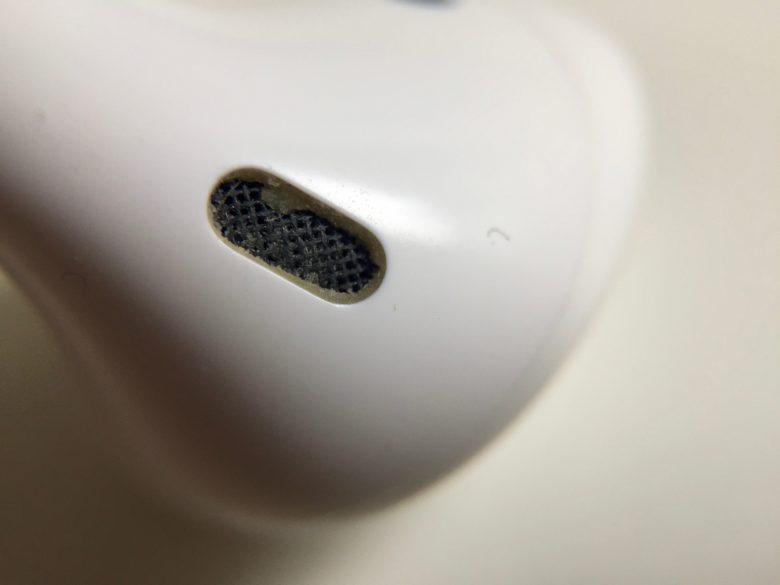 A hole in an AirPod that's slightly dirty.