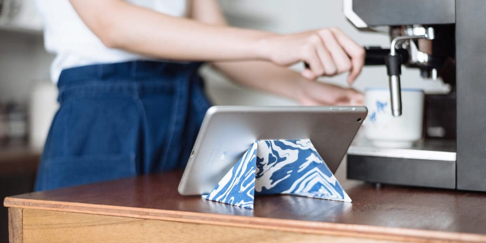 This stand props up your iPhone or iPad, then folds into a thin sheet for easy transport.