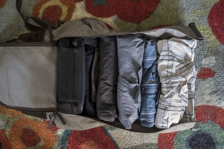 Inside is a cord-organizing case, jeans, shorts and three shirts. Socks and underwear hidden behind