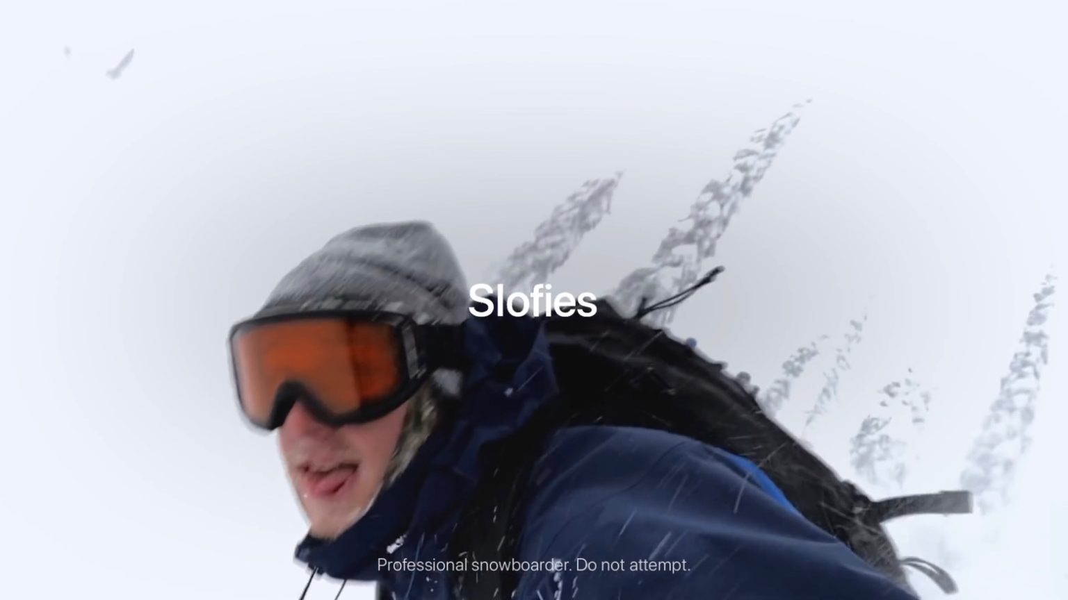 A snowboarder takes a slofie