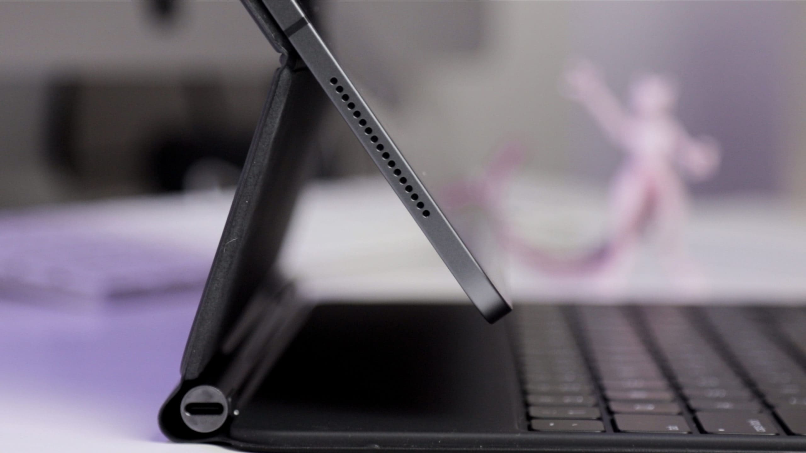 The hinge of the Magic Trackpad is adjustable, and offers pass-through power.