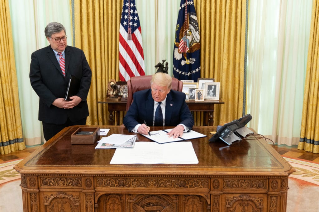 President Trump signs the executive order.