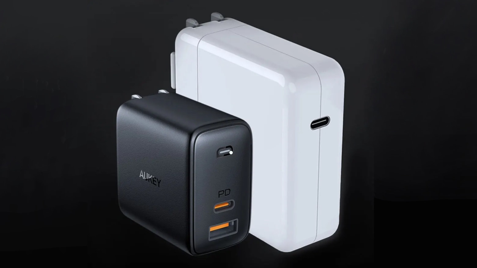 A bulky Apple charger next to a svelte Aukey one.