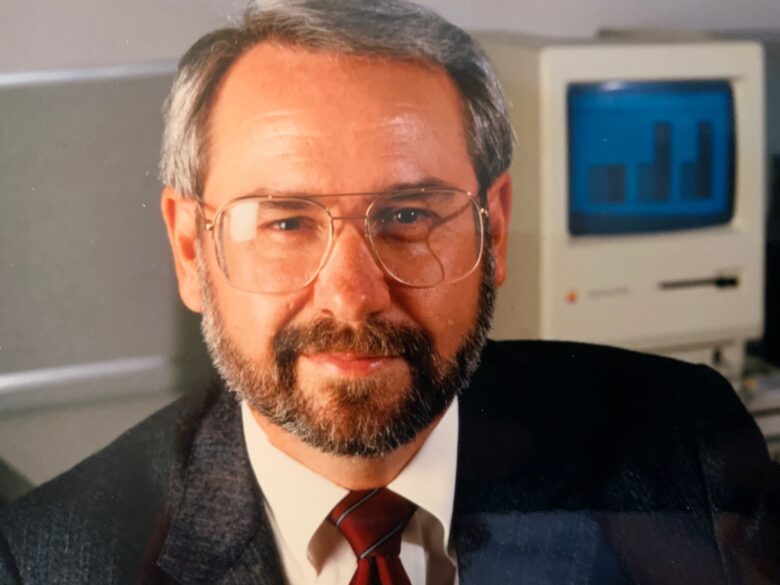 Del Yocam, pictured during his Apple days. Note the Mac behind him.