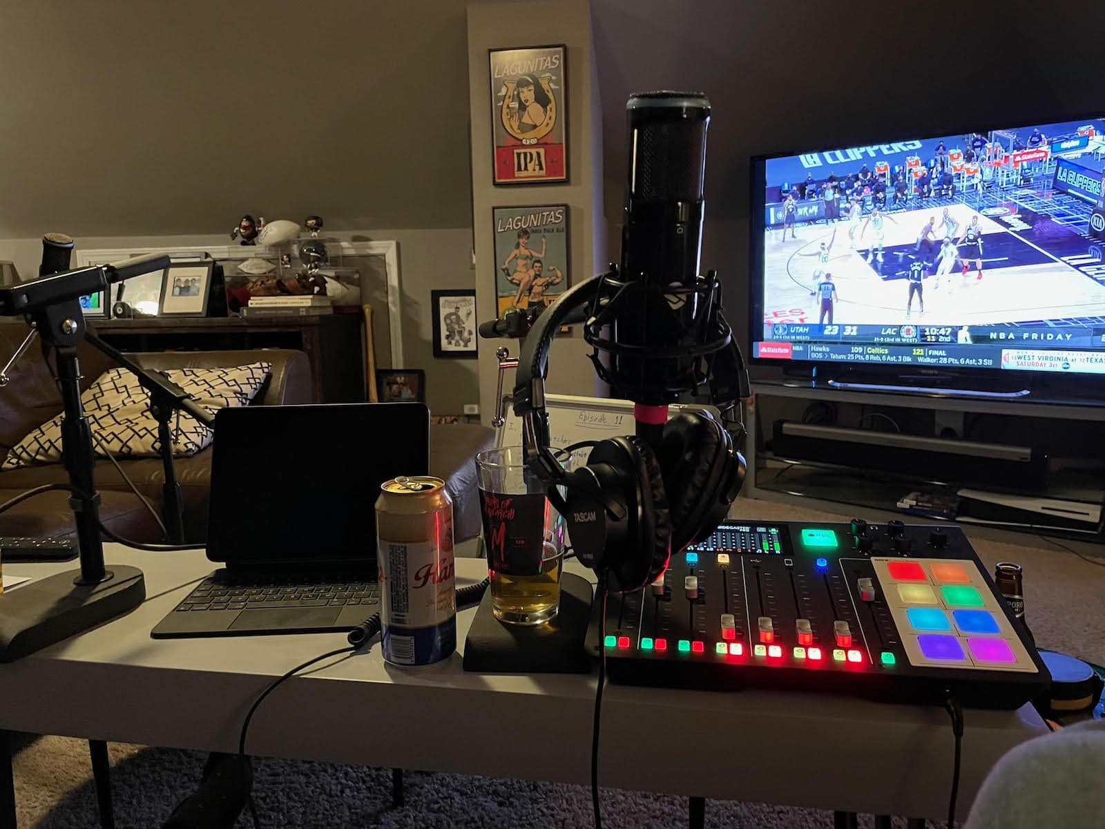 This just screams "podcasting," right? Laptop. Console. Microphone. Headphones. Beer.