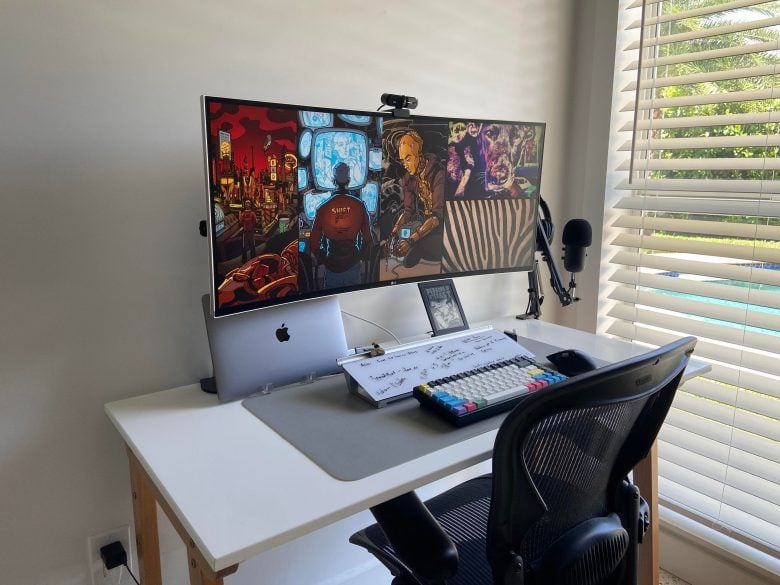 A MacBook Pro and widescreen display setup has a secret weapon: a desktop whiteboard.