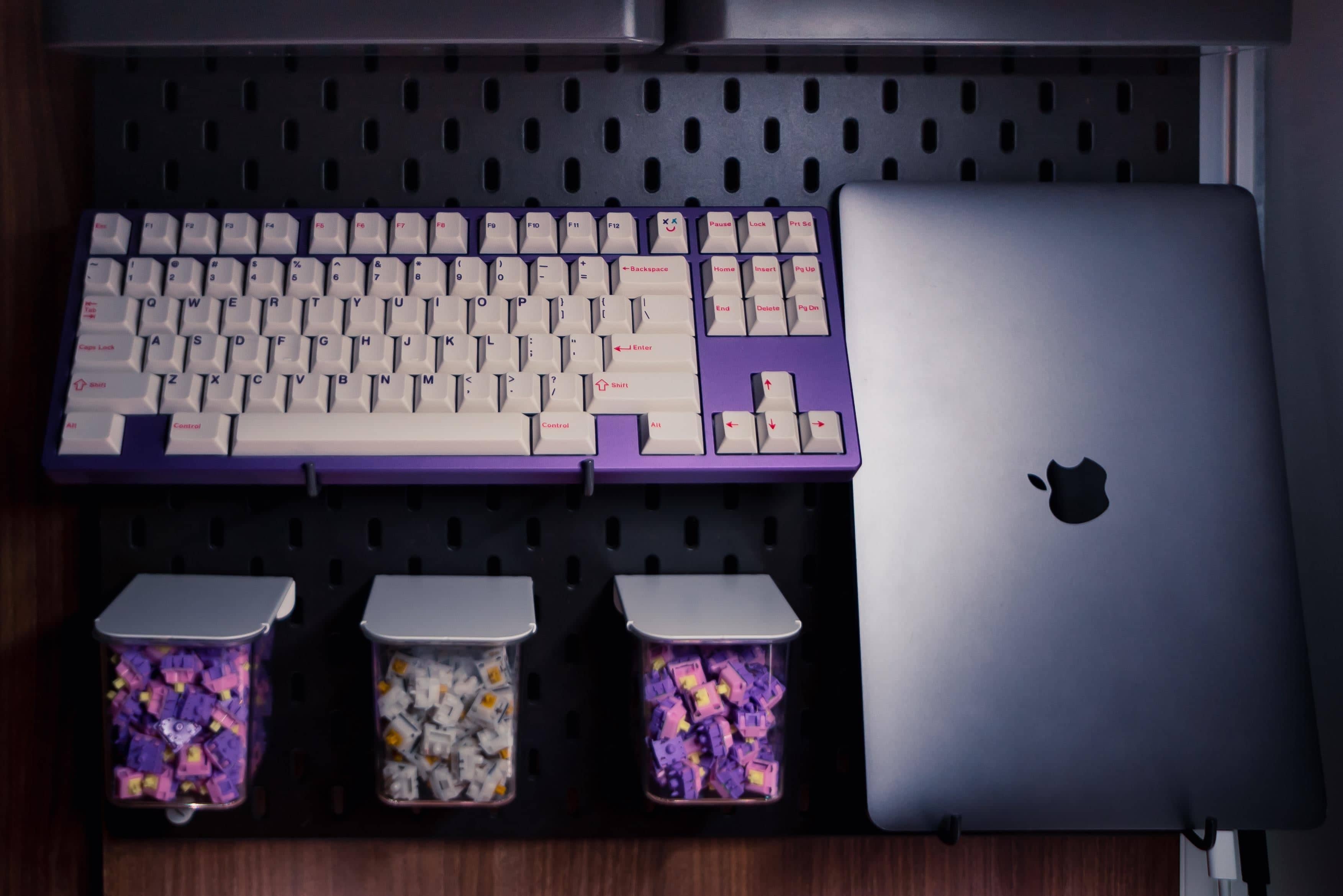 A pegboard, a few hooks and you've got a whole backup mechanical keyboard situation. Not to mention the MacBook Pro.