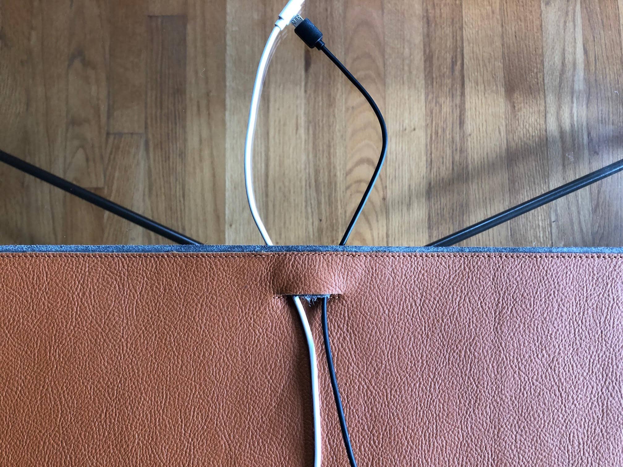 Harber London's desk mat features a cable pass-through.