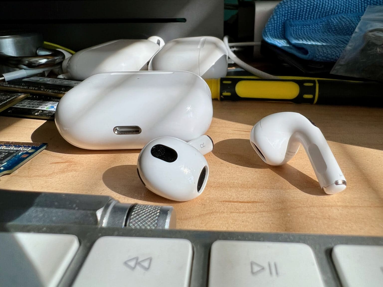 AirPods 3 on messy desk