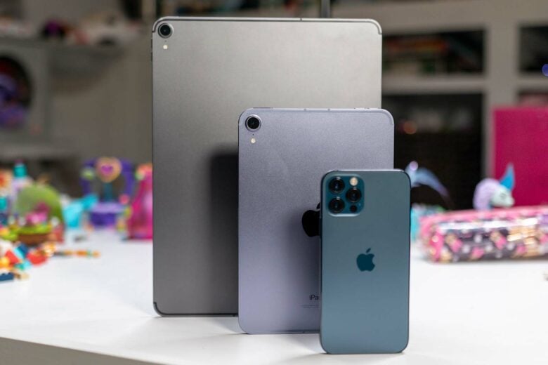 12.9" iPad Pro, iPad mini 6, and iPhone 12 standing on desk: The iPad mini joins the iPad Pro, Air and iPhone in the modern, square design.
