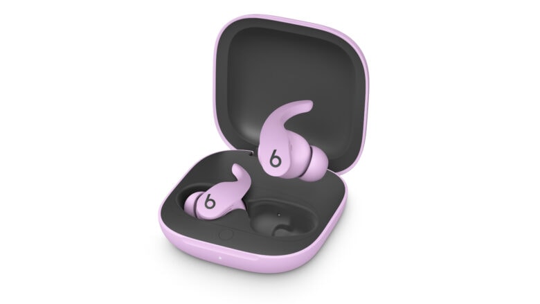 Beats Fit Pro earbuds, in Stone Purple color, sit in their chargin gcase