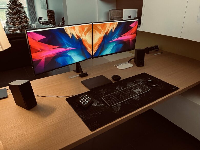 Dual, mounted monitors and an M1 hidden Mac mini make for a clean desktop.