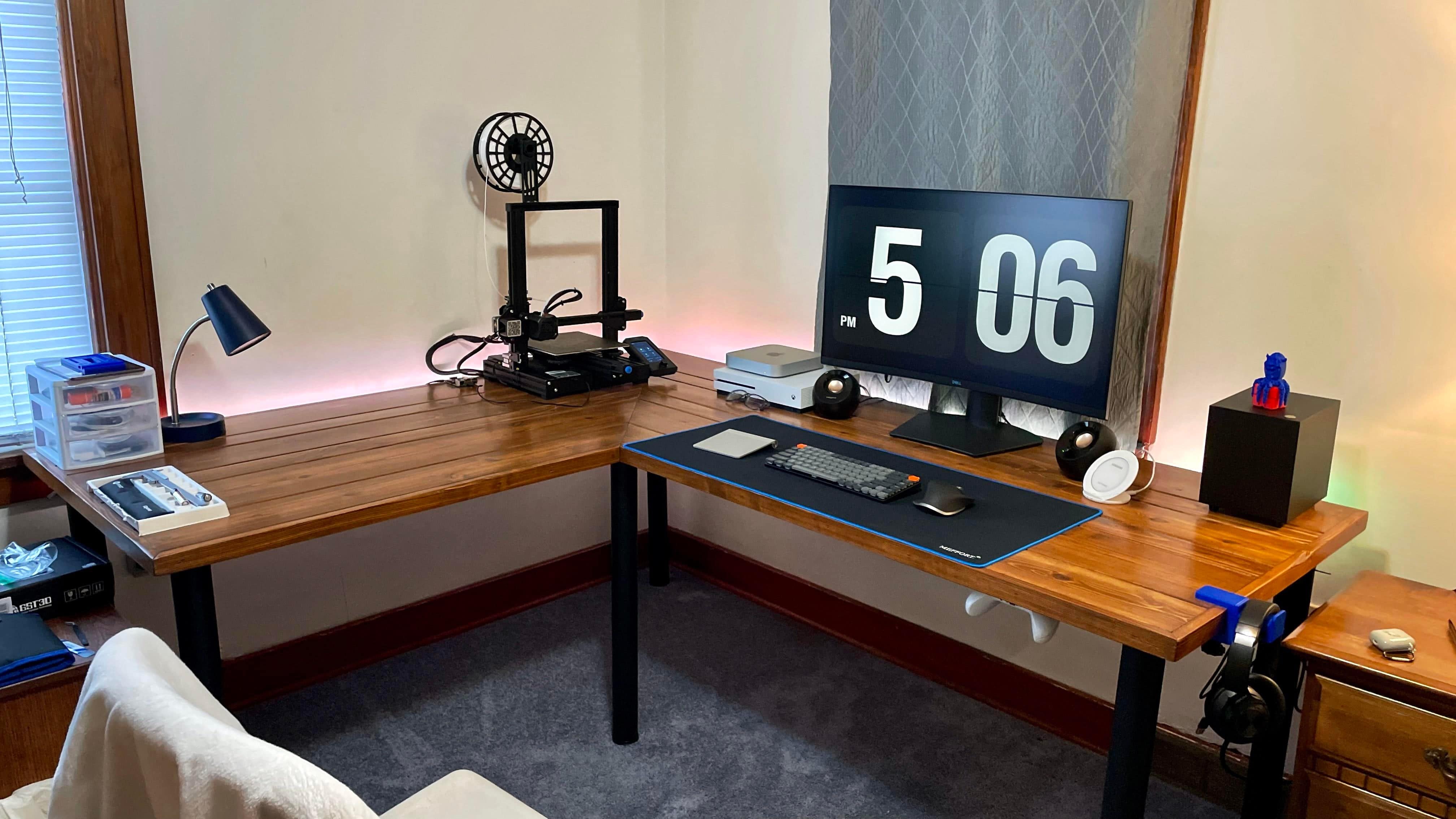 The 3D printer at left helped make other parts of this computer setup.