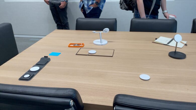 The accessory testing room features cases and MagSafe accessories on the tables.