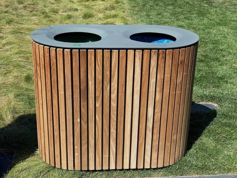 The combined trash and recycling bins are made of wood to blend in more naturally with the Apple Park environment.