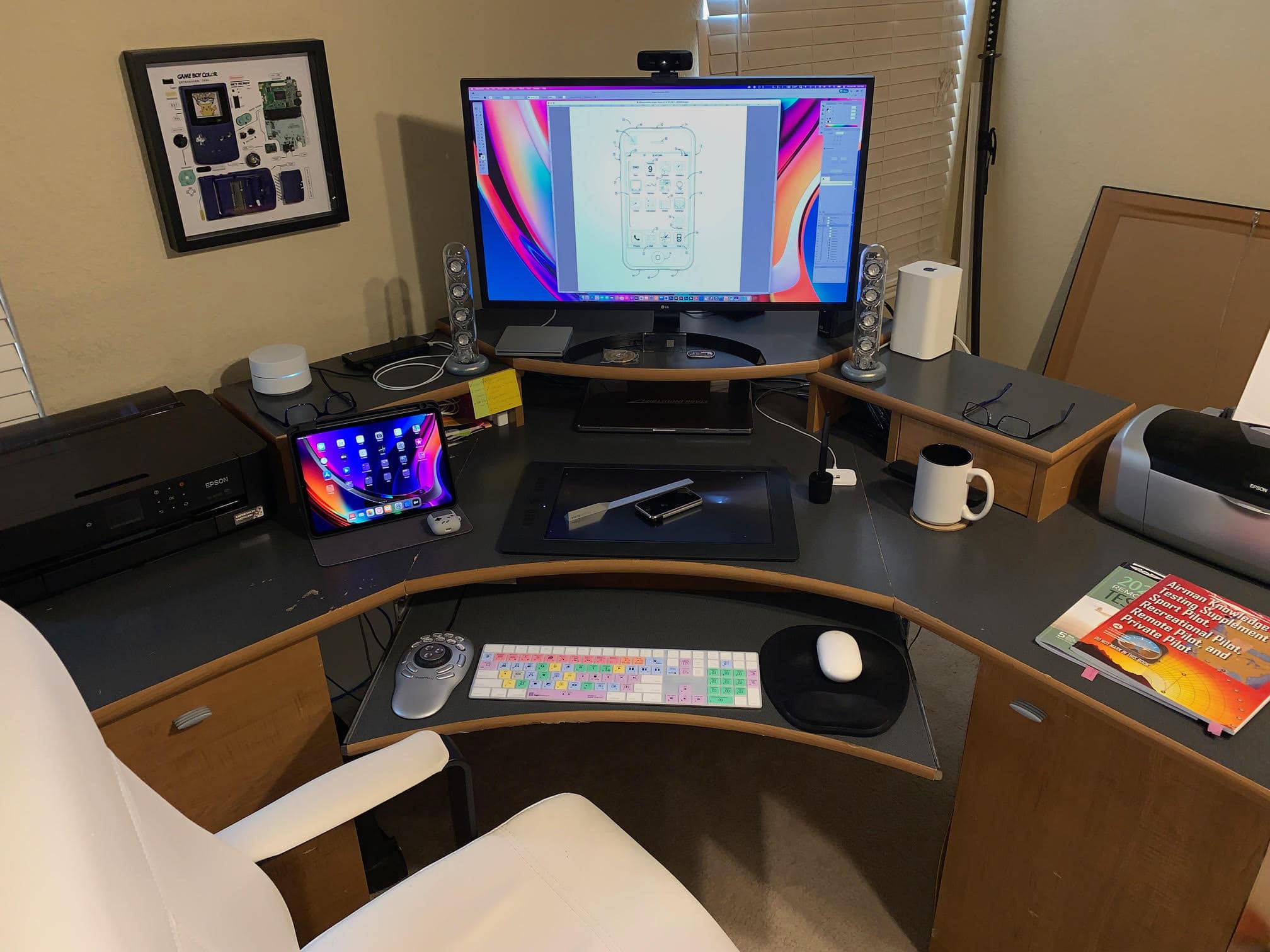 A MacBook Pro and a 4K LG display anchor Smelker's setup.