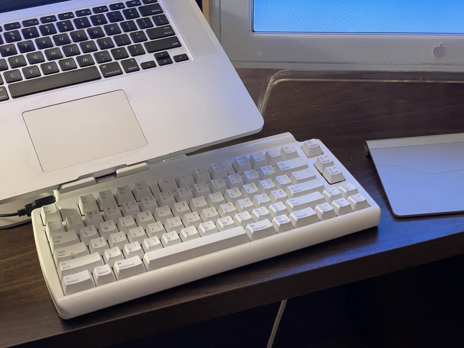 The Matias keyboard on my desk. The Mac sits on the mStand next to an Apple Cinema Display and Magic Trackpad.