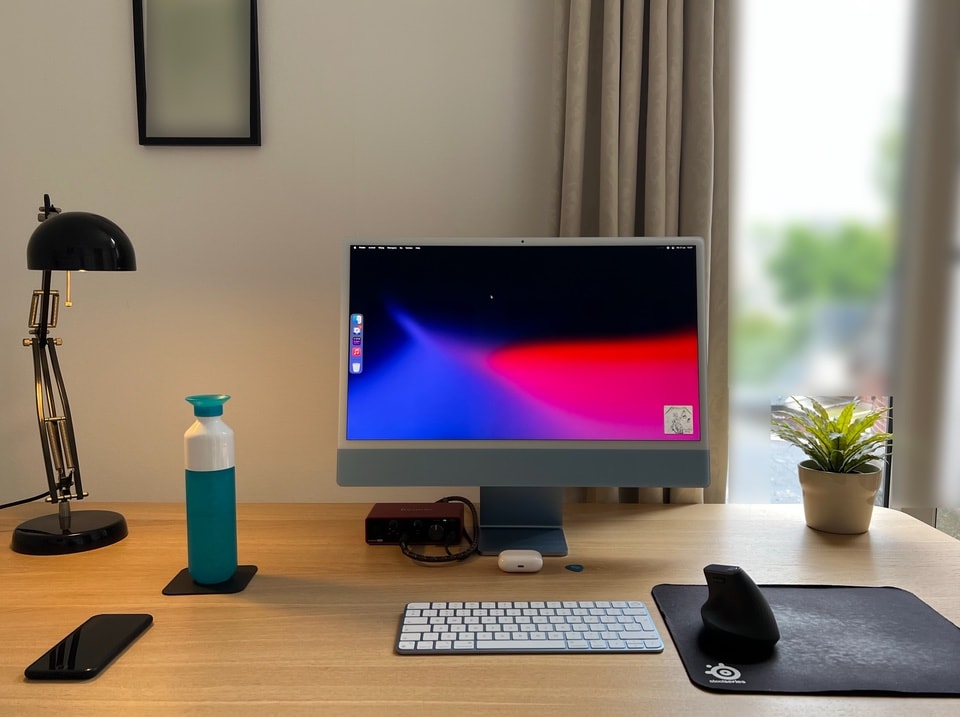 This computer setup's centerpiece is a 24-inch iMac.