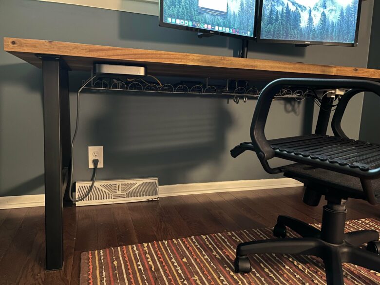 Two Ikea trays under the desk handle cable-management chores.