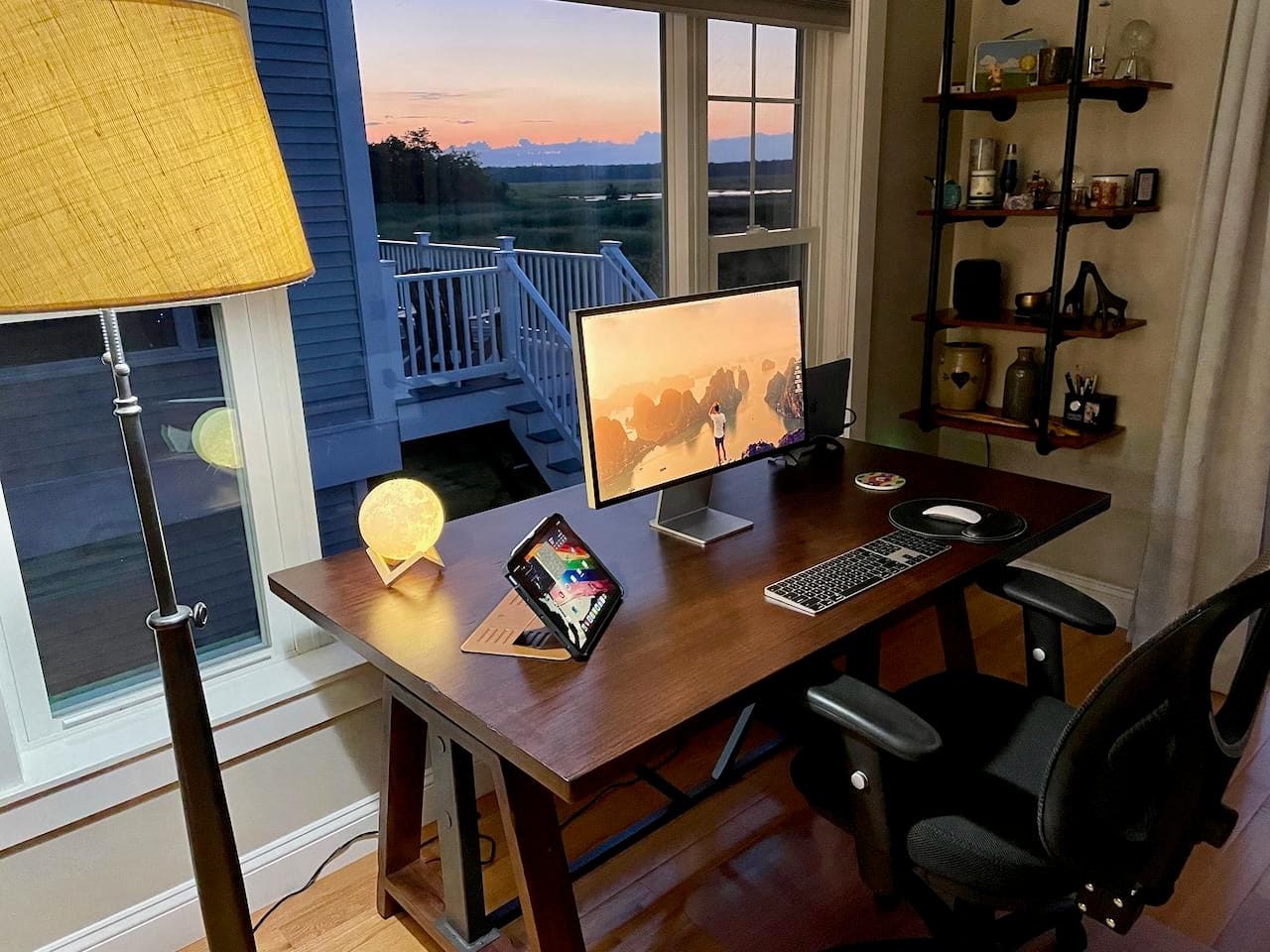 An M1 MacBook Pro and Studio Display enjoy the sunset by the coast north of Boston.