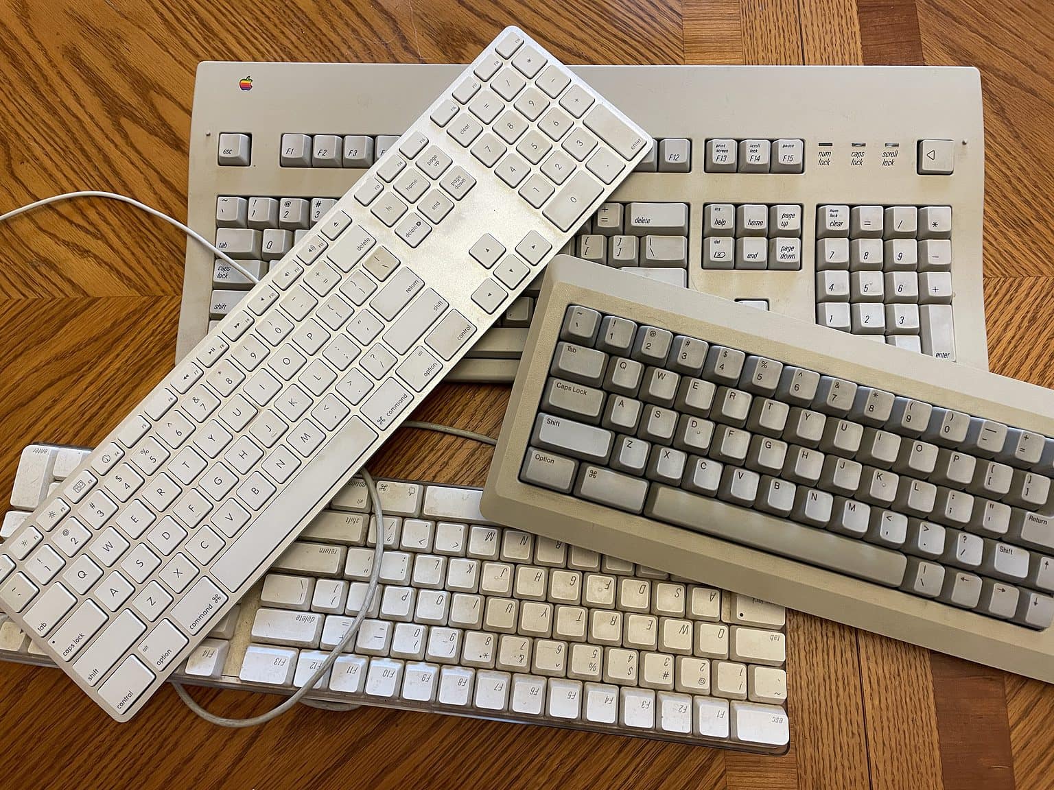 Mac keyboards in a pile.