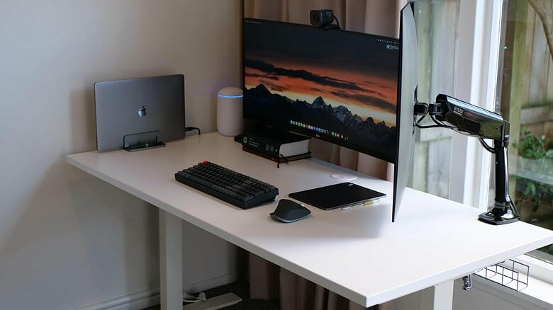 Here's the setup as it appeared on the old desk, before PI replaced it with a "proper" standing desk. This shot also shows the portrait-mode display's Silex Ergonomics mount.