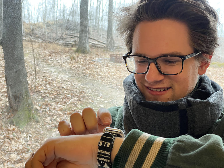Me wearing a varsity jacket and gray scarf while pretending to use my Apple Watch. Here I am sporting the Stark band while pretending to stand outside and use my Apple Watch.