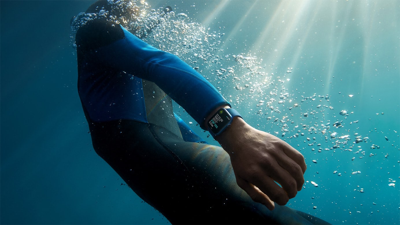 Person swimming underwater wearing Apple Watch